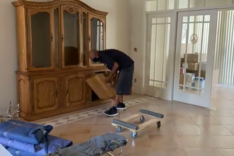 Setting an antique china hutch in place